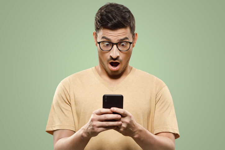 A smartphone user reacting to shock advertising