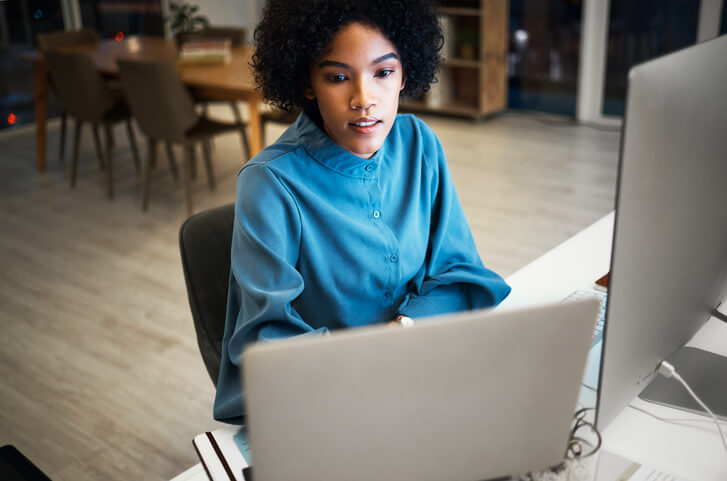 A focused female SEO manager working in an office