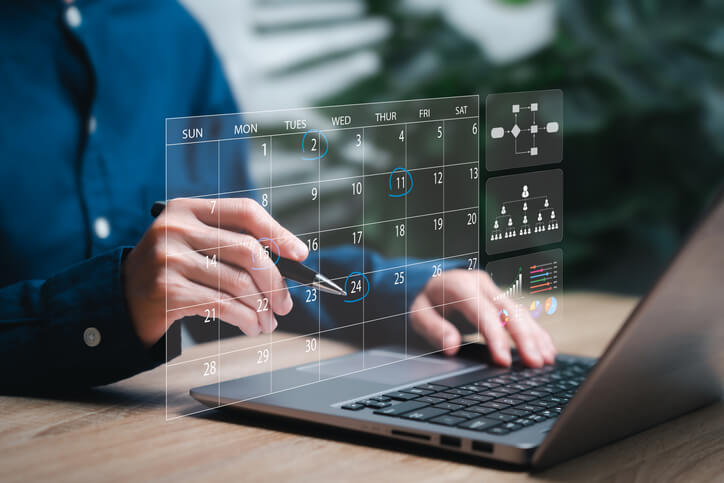 A social media manager planning campaigns in Vancouver represented on a content calendar and analytics on screen