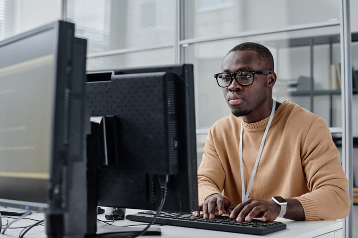 A cybersecurity student practicing network security skills in a hands-on training lab.