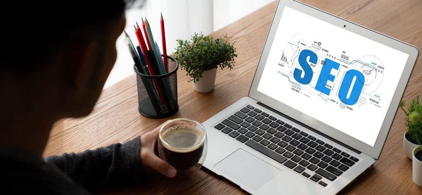 A digital marketing student reviewing backlink audit on a laptop