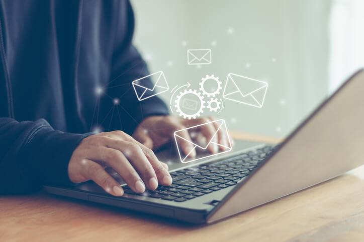 Marketing automation specialist building email workflows on a laptop