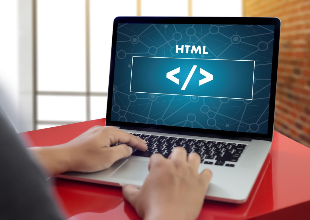 A Vancouver digital marketing student learning basic HTML code on a laptop