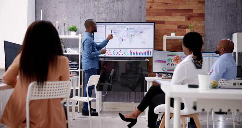 A data analyst visualizing business intelligence dashboards during classroom training