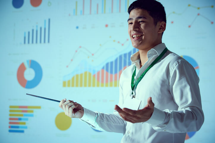 Business analytics student presenting data insights during a classroom project