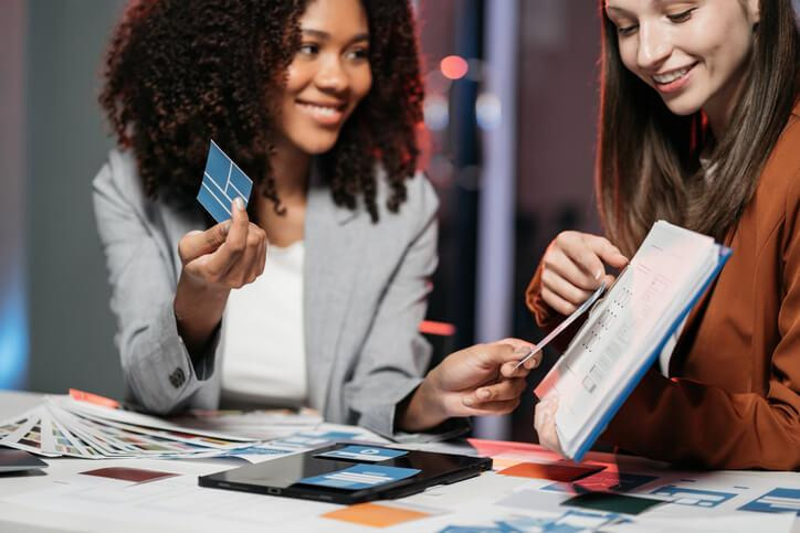 A marketing team comparing two advertisement designs during ad testing