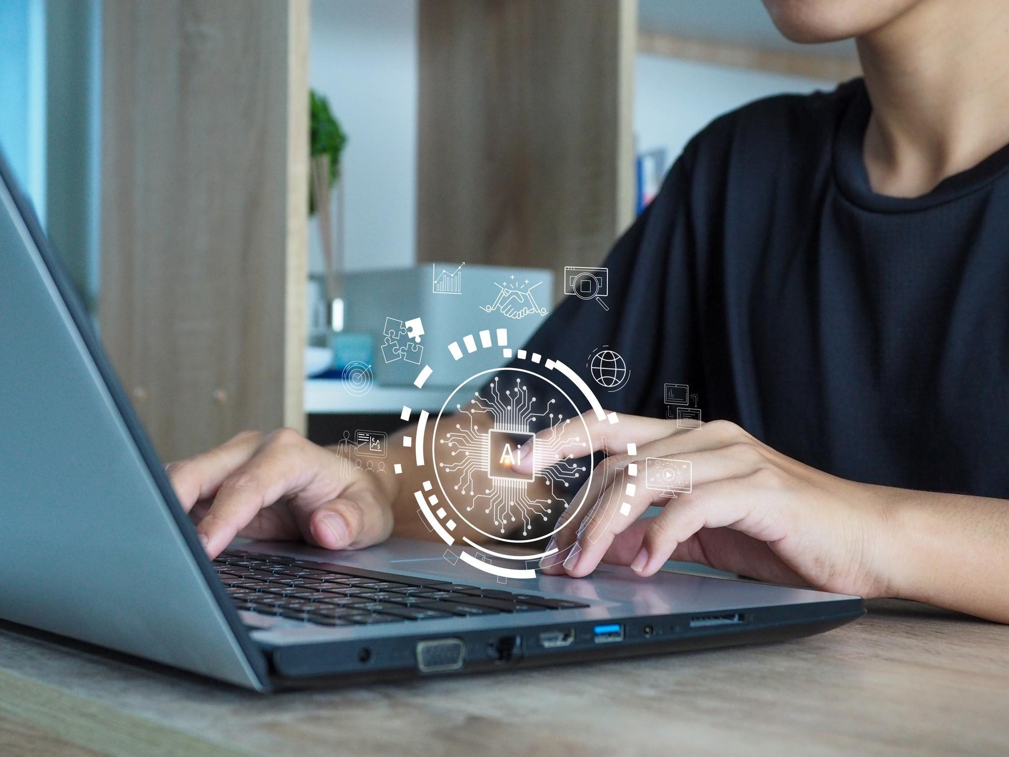 A student exploring artificial intelligence tools for business management on a laptop
